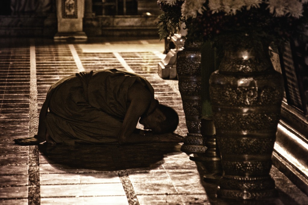 monk bowing to buddha